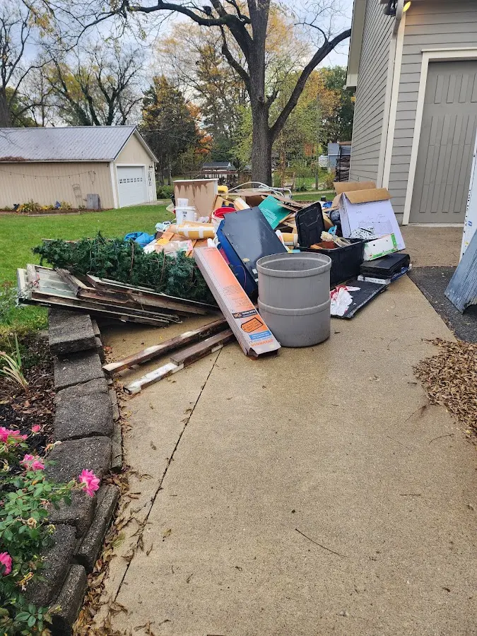 Dumpster being loaded with debris for Estate Cleanout Dumpster Rental in Norwich